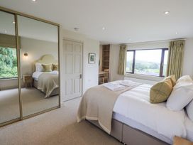 A bedroom with a bed and window at Rowanhill in Kendal