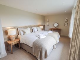 A bedroom with two beds and a desk at Rowanhill in Kendal