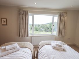 A bedroom with two beds and a view at Rowanhill in Kendal