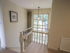 A staircase with a railing and window at Rowanhill in Kendal