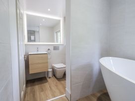 A bathroom with a bathtub and sink at Rowanhill in Kendal