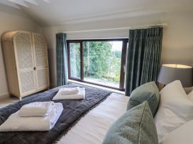 A bedroom with a bed and wardrobe at Rowanhill in Kendal