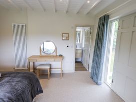 A bedroom with a bed, desk and chair at Rowanhill in Kendal