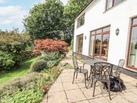 A garden with a table and chairs at Rowanhill in Kendal
