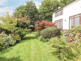 A garden with a pathway leading to a house at Rowanhill in Kendal