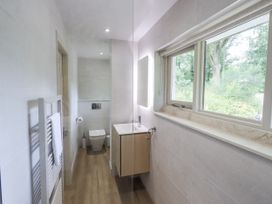 A bathroom with a sink, toilet, and window at Rowanhill in Crook near Staveley