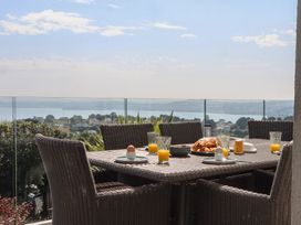 An outdoor dining area with a table set for breakfast at Seacroft in Torquay