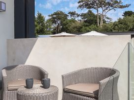 An outdoor seating area with chairs and a table at Seacroft in Torquay