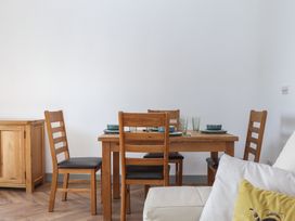 A dining room with a table and chairs at Seacroft Torquay