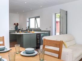 A kitchen with dining table and chairs at Seacroft in Torquay