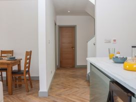A dining room with a table and chairs at Seacroft in Torquay