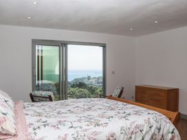 A bedroom with a bed and dresser at Seacroft in Torquay