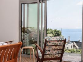 A living room with an armchair and table at Seacroft in Torquay