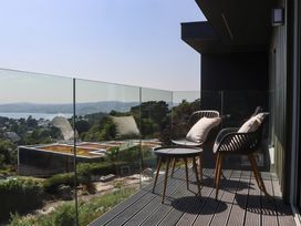 A balcony with chairs and a table at Seacroft in Torquay