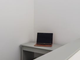 A desk with a laptop in a home office at Seacroft in Torquay