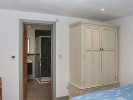 A bedroom with a wardrobe and bathroom door at Seacroft in Torquay