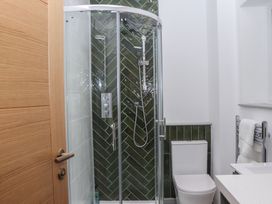 A bathroom with a shower and toilet at Seacroft in Torquay
