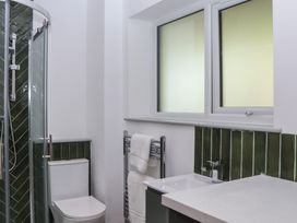 A bathroom with a shower, toilet, and sink at Seacroft in Torquay