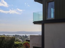 A building with a glass railing and window overlooking water at Seacroft in Torquay