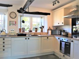 A kitchen with appliances and utensils at The Little Farmhouse in Carnforth