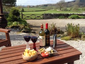 A table with wine glasses and snacks at The Little Farmhouse in Carnforth