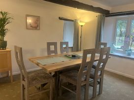 A dining room with a table and chairs at The Old Farmhouse at Brackenthwaite Farm Yealand Redmayne near Arnside