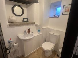 A bathroom with a toilet and sink at The Old Farmhouse at Brackenthwaite Farm Yealand Redmayne near Arnside
