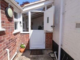 An entrance with an open door and a potted plant at Beehive in Beccles