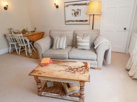 A living room with a sofa and coffee table at Beehive in Beccles