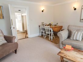 A living room with a dining table and sofa at Beehive in Beccles