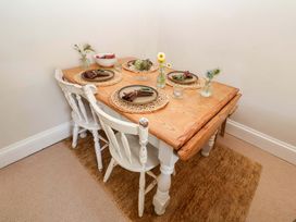 A dining room with a wooden table and chairs at Beehive in Beccles
