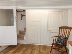 A room with a staircase and a chair at Beehive in Beccles