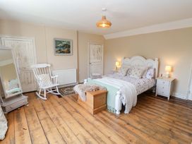 A bedroom with a bed and rocking chair at Beehive in Beccles