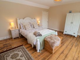 A bedroom with a bed and wardrobe at Beehive in Beccles