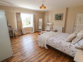 A bedroom with a bed and window at Beehive in Beccles