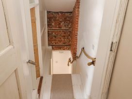 A staircase with a brick wall and handrail at Beehive in Beccles