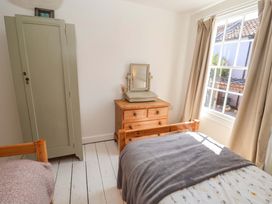 A bedroom with a bed and a wardrobe at Beehive in Beccles