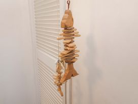 A wooden fish decoration hanging on a wall at Beehive in Beccles