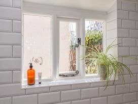 A window with a plant and cosmetic items at Beehive in Beccles