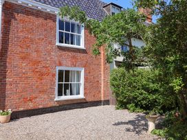 An exterior view of a brick wall with a window and plants at Beehive in Beccles