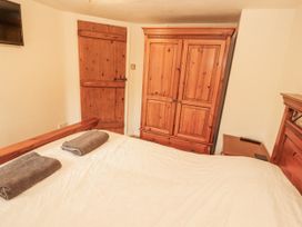 A bedroom with a bed and wardrobe at 2 Bens Row near Newby Bridge
