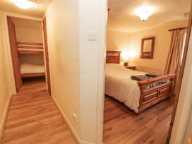 A bedroom with a double bed and bunk beds at 2 Bens Row Backbarrow near Newby Bridge