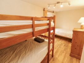 A bedroom with bunk bed and single bed at 2 Bens Row in Backbarrow near Newby Bridge