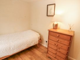 A bedroom with a bed and chest of drawers at 2 Bens Row Backbarrow near Newby Bridge