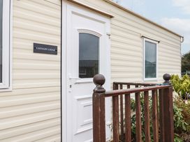 An entrance with a door and railing at Carnaby Lodge in South Chard