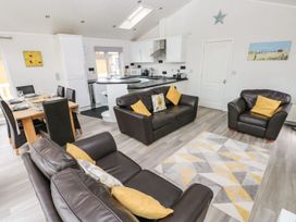 A living room with a sofa and dining area at Erisa 