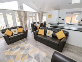 A living room with sofa and dining area at Erisa