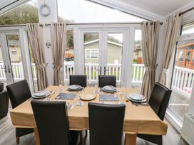 A dining room with a table set for meals at Erisa