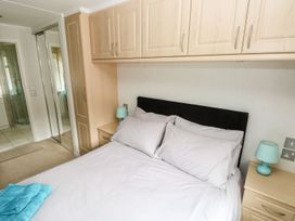 A bedroom with a bed and storage units at Erisa