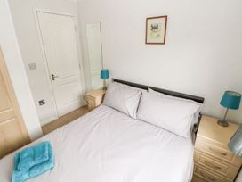 A bedroom with a bed and bedside table at Erisa 